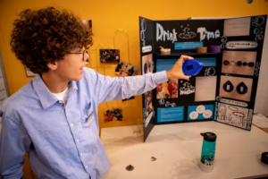 Youth displaying invention at Invention Lab 2023