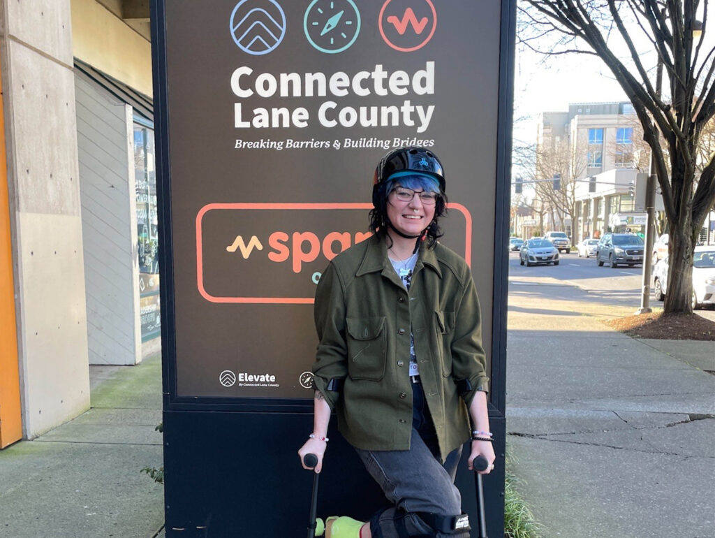 Elliott in front of Connected Lane County Signage.