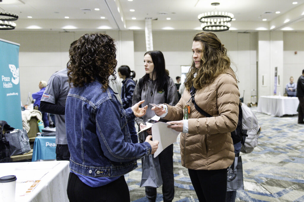 Youth receiving business information at the hiring fair