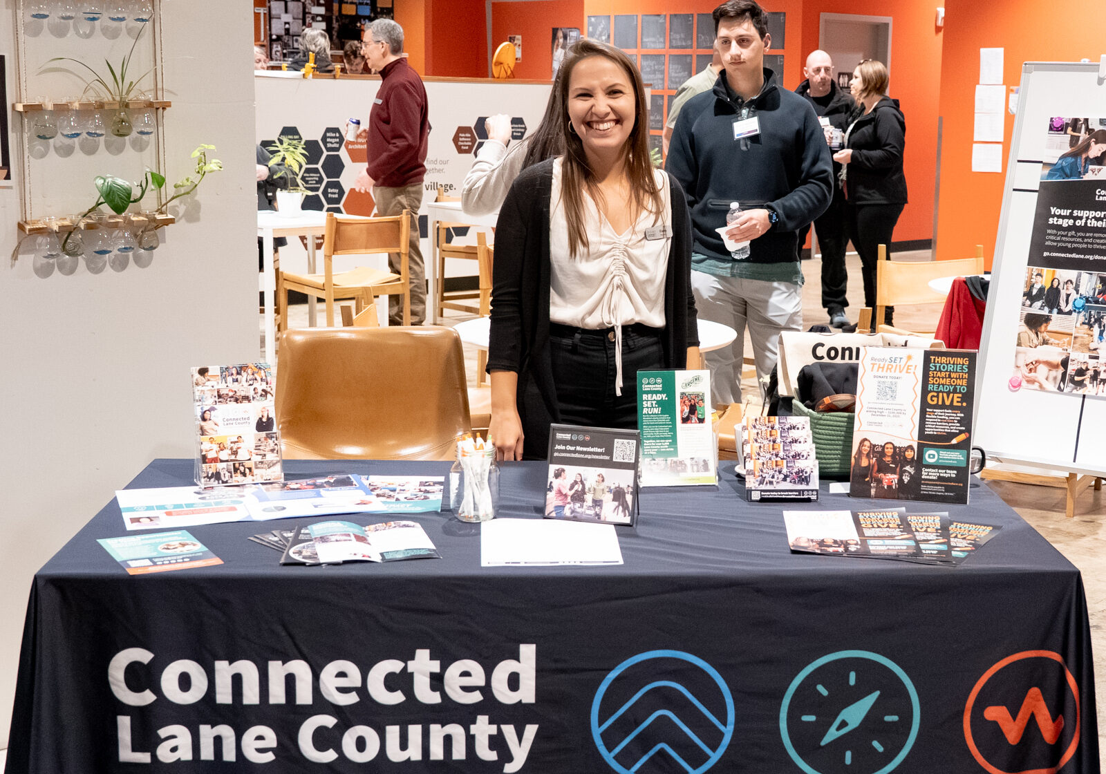 Connected Lane County Staff member smiling at a table booth