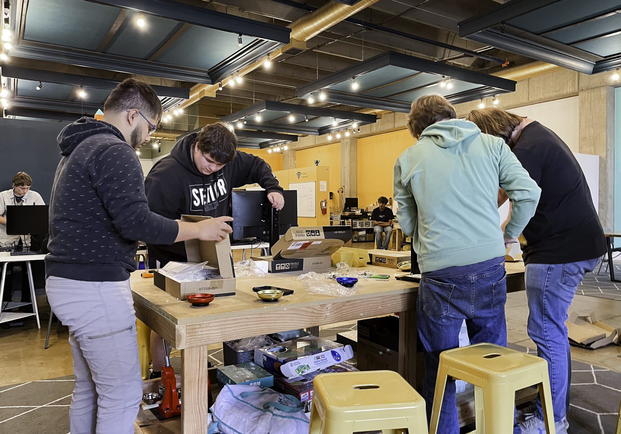 youth setting up computers in tech excelerator